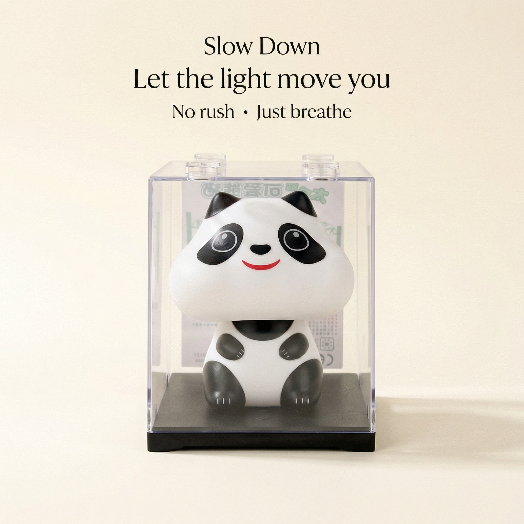 Solar panda figurine displayed in clear acrylic gift case with black base