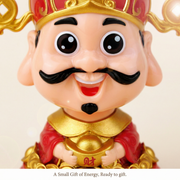 Close-up detail of chibi Caishen face holding a gold ingot on a solar desk figurine