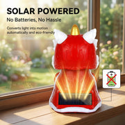 Back view of solar lion dance cat showing solar panel on windowsill in natural light